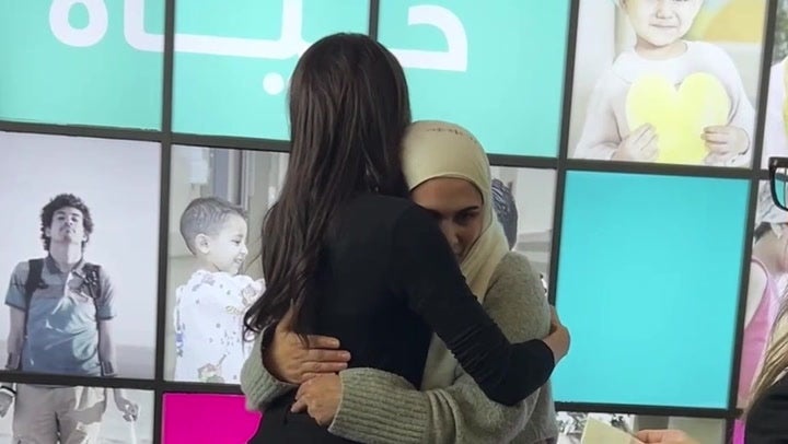 Meghan hugs mother of cancer patient on her humanitarian trip to Jordan earlier this year (PA)