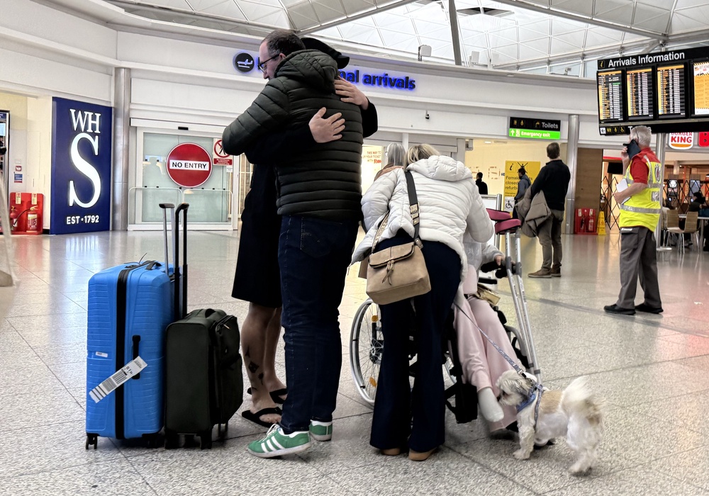 Amelia Reid (in wheelchair) and her partner, Samuel Sharp (obscured) arrived at London Stansted Airport (Paul Marriott/PA) (PA Wire)