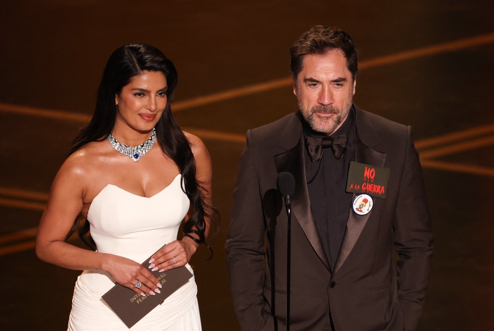 Presenting alongside Priyanka Chopra, Javier Bardem declared ‘No to war and free Palestine,’ before awarding the Oscar for Best International Feature Film (AFP/Getty)