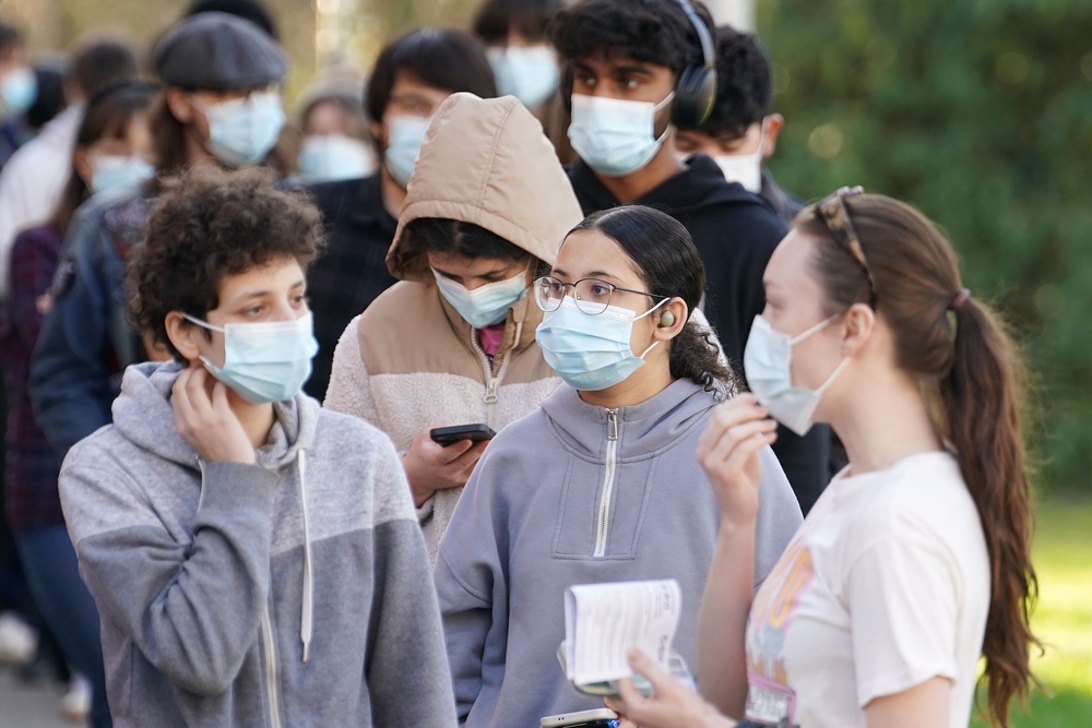 Students wait in line at the entrance to the sports hall at the University of Kent campus in Canterbury, where the rollout of a meningitis B vaccine has begun (Gareth Fuller/PA) (PA Wire)