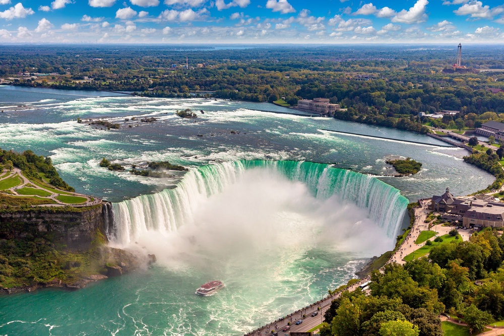 Niagara Falls is a sight and sound you’ll never forget. Pictured is the epic Horseshoe Falls, which straddles the U.S./Canadia border. Goat Island, on the U.S. side, can be seen on the far left (Getty Images)