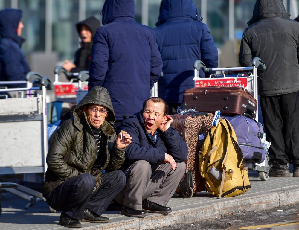 North Korean workers wait for their flight at the airport of Vladivostok (AFP/Getty)