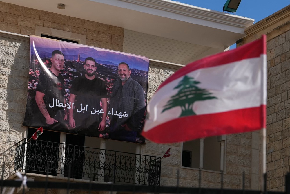 A banner depicting the portraits of three men killed by an Israeli airstrike hangs on the wall of a building in the southern Lebanese Christian border village of Ain Ebel (AFP/Getty)