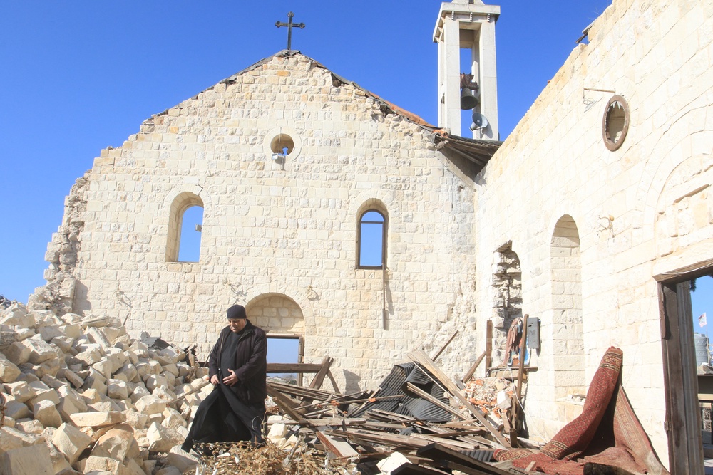 A worshipper walks inside the badly damaged St George’s Church, following a Christmas Mass in the southern Lebanese village of Yaroun near the border with Israel (AFP/Getty)