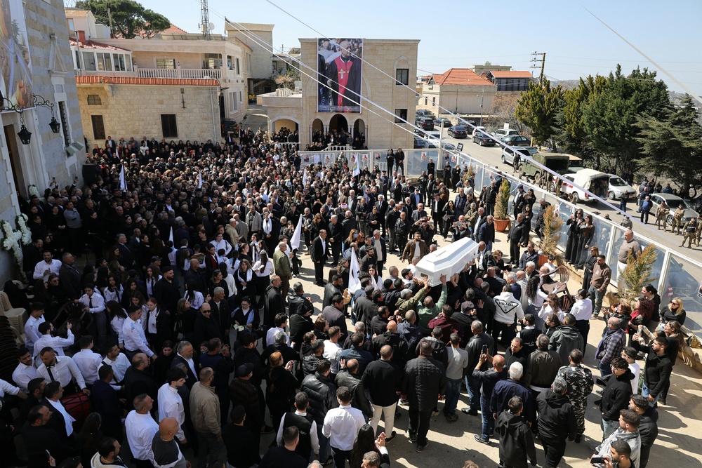 Residents of the Christian Lebanese border village of Qlayaa carry the coffin of the village’s priest (AFP/Getty)