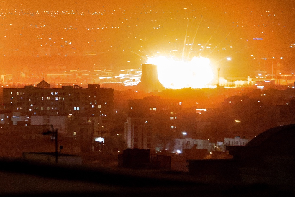 An explosion erupts following strikes near Azadi Tower close to Mehrabad International Airport in Tehran on March 7 (AFP/Getty)
