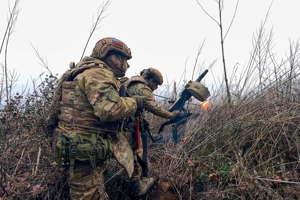 Russian soldiers fire a grenade launcher towards Ukrainian positions on an undisclosed location in Ukraine (AP)