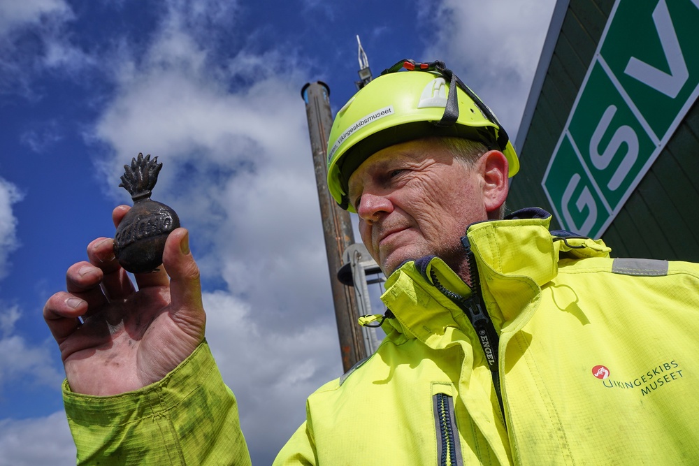 Morten Johansen, head of maritime archaeology at Denmark's Viking Ship Museum, shows a metal insignia recovered from the wreck of Danish flagship ‘Dannebroge’ that sank during the Battle of Copenhagen in 1801, (Associated Press/James Brooks)