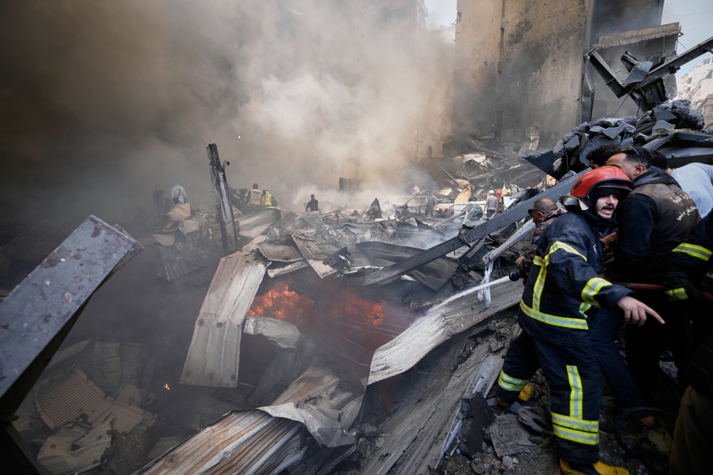Firefighters, first responders, and volunteers work on smouldering debris at the site of an Israeli airstrike in Beirut, on 8 April (Copyright 2026 The Associated Press. All rights reserved.)