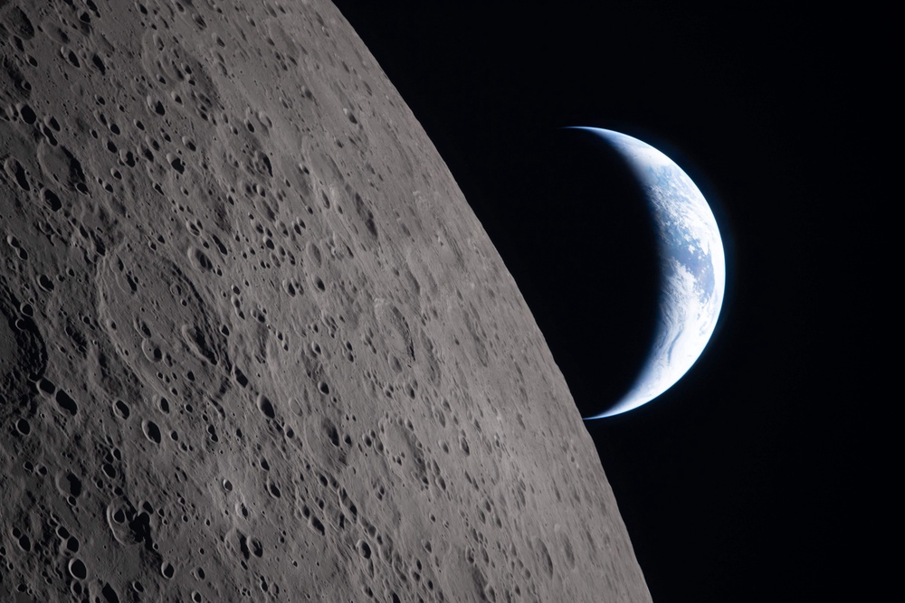 The Earth sets behind the Moon during a lunar flyby (Nasa/AP) (NASA)