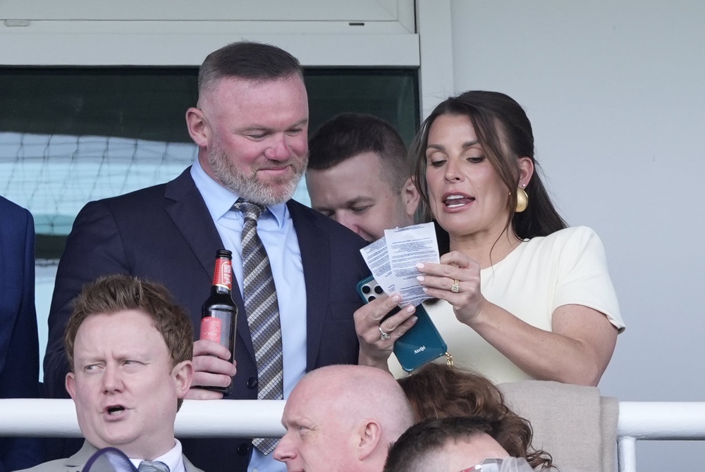 Wayne Rooney and Coleen Rooney in the grandstand during the William Hill Handicap Hurdle on Grand National Day of the Randox Grand National Festival 2026 at Aintree Racecourse (Peter Byrne/PA) (PA Wire)