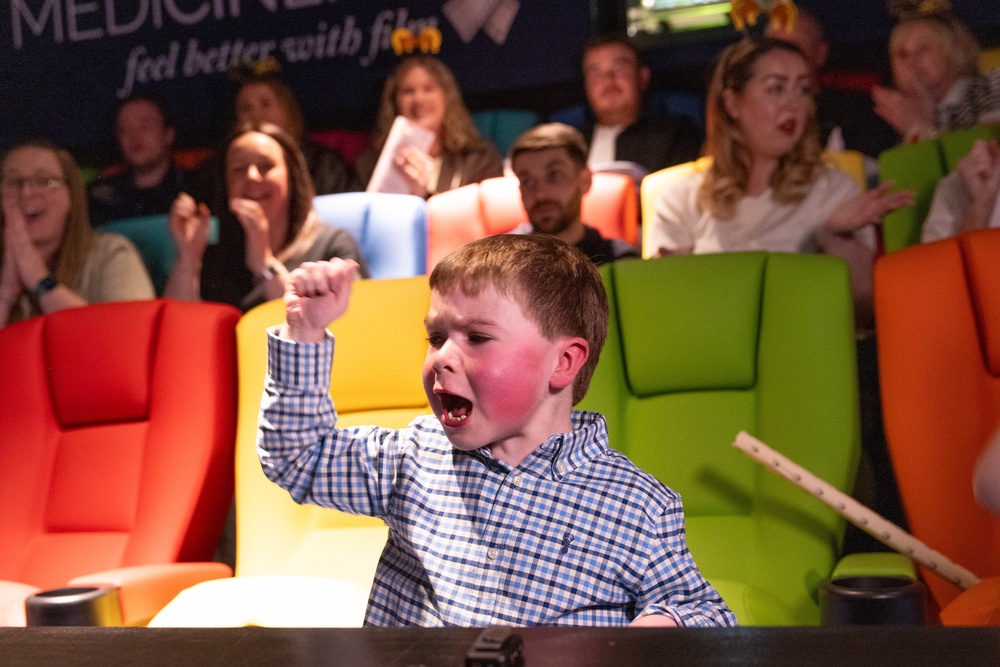 Oliver Christie, five, watches the Randox Grand National in the MediCinema at Alder Hey Children’s Hospital in Liverpool with his friends and family (James Speakman for The Jockey Club/PA) (PA Wire)