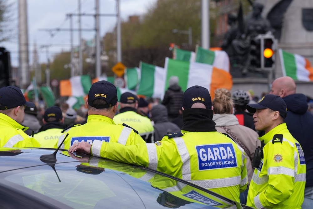 Gardai watch protesters on O’Connell Street in Dublin (Niall Carson/PA) (PA Wire)