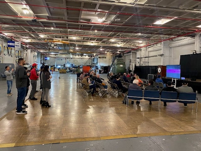 Guests watch the Artemis II mission at the USS Hornet Museum on Friday April 10, 2027 (Russell Moore / USS Hornet Museum)