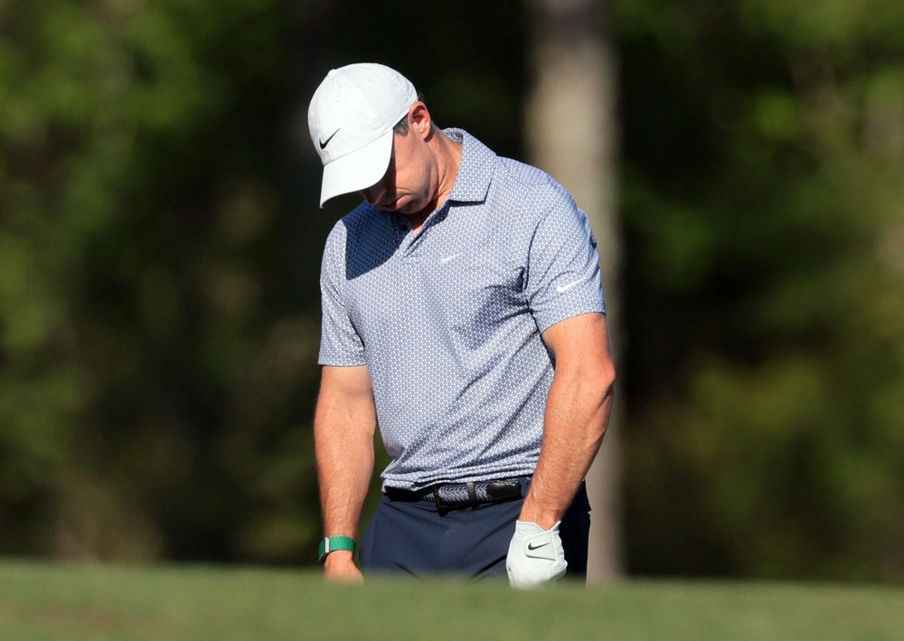 Rory McIlroy reacts after finding the water (REUTERS)