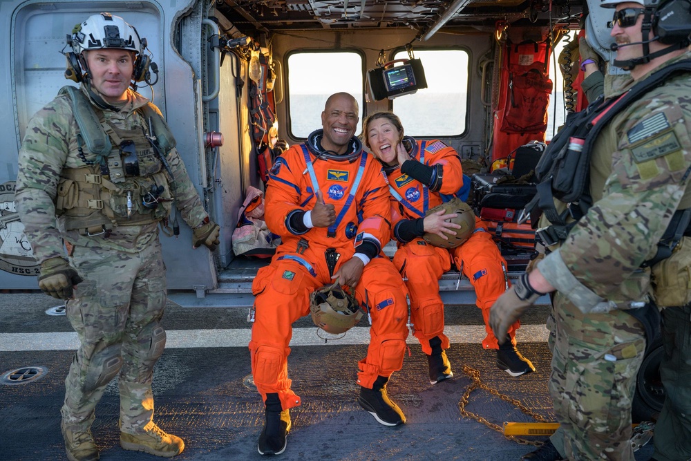Artemis II pilot Victor Glover and mission specialist Christina Koch make known their feelings after safely landing on the USS John P. Murtha on April 10, 2026. (Bill Ingalls/NASA via Getty Images)
