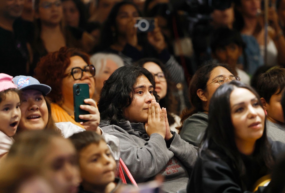 People watch a live broadcast before splashdown during an Artemis II splashdown party at the Columbia Memorial Space Center on April 10, 2026 in Downey, California (Mario Tama/Getty Images)