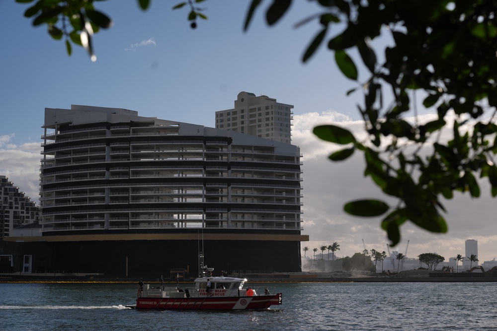 A City of Miami Fire-Rescue boat patrols in front of the former Mandarin Oriental Hotel on Brickell Key ahead of its controlled implosion (AP)