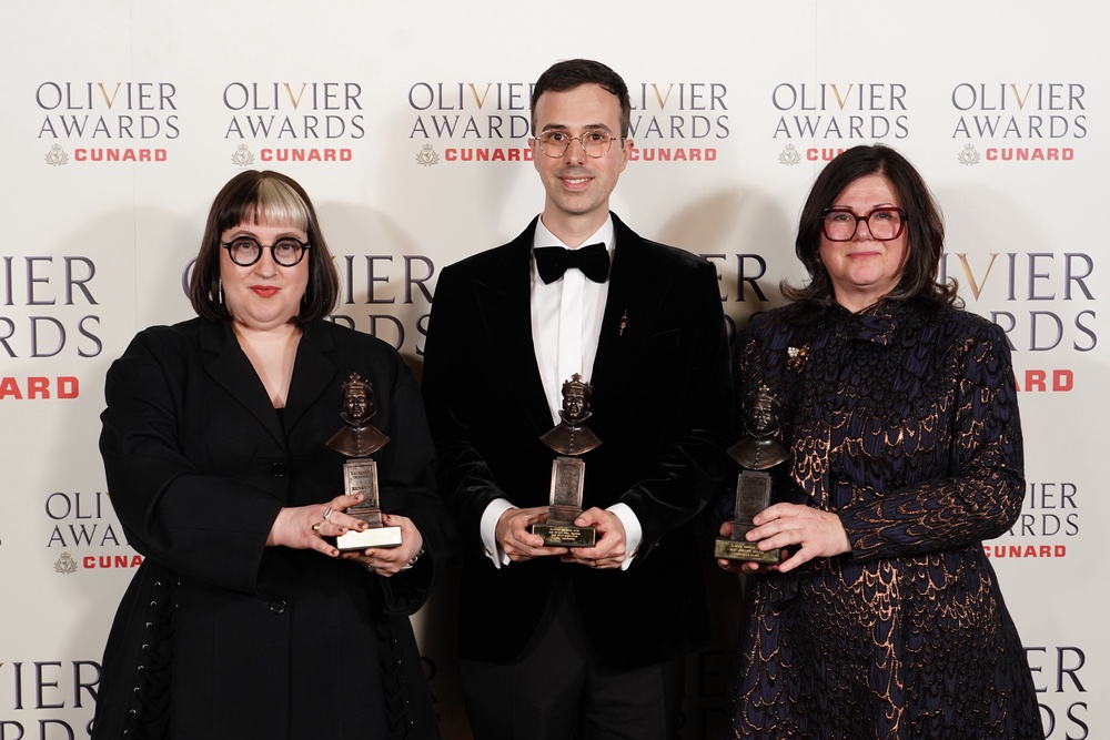 Tahra Zafar and Gabriella Slade with their best costume design award and Luke Sheppard with his best director award for Paddington (Ian West/PA) (PA Wire)