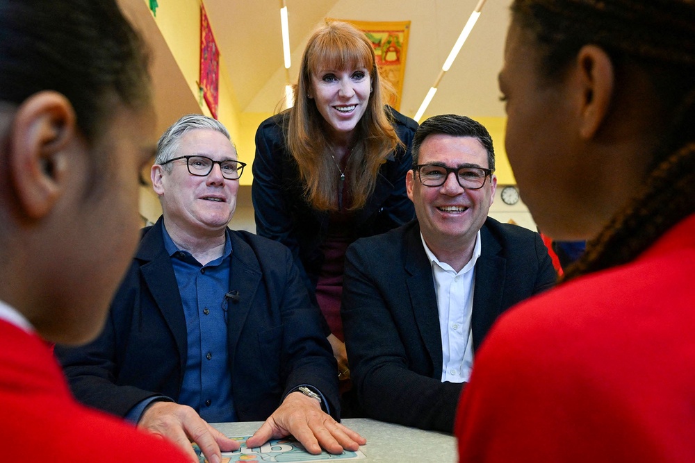 Angela Rayner and Andy Burnham put on a united front as they joined the prime minister on a visit to a school in Ashton-under-Lyne ahead of local elections in May (PA)