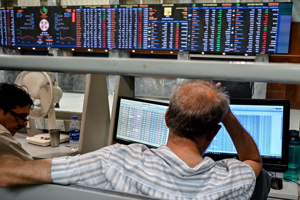 Stockbrokers react during trading hours at the Pakistan Stock Exchange in Karachi, 13 April (AFP/Getty)