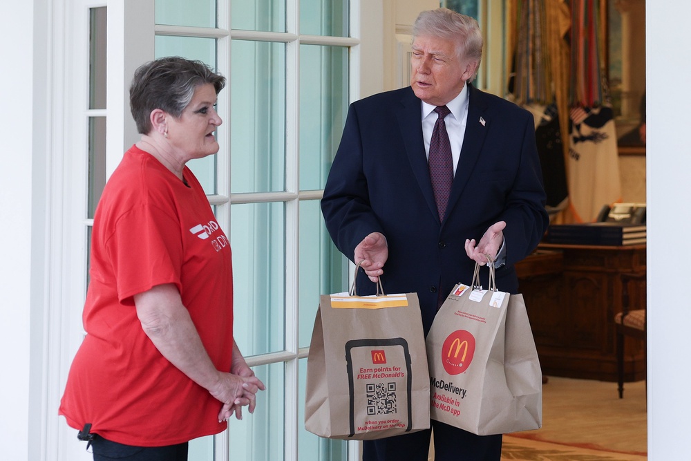 Simmons stood awkwardly by Trump's side as he took a range of questions from reporters (Getty)