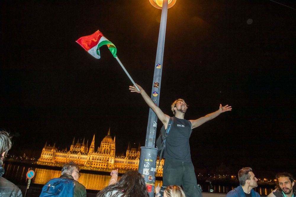 People celebrate in the streets after Hungarian Prime Minister Viktor Orban conceded defeat to Peter Magyar, leader of the pro-European conservative TISZA party, in Budapest, on April 12, 2026 (AFP via Getty Images)