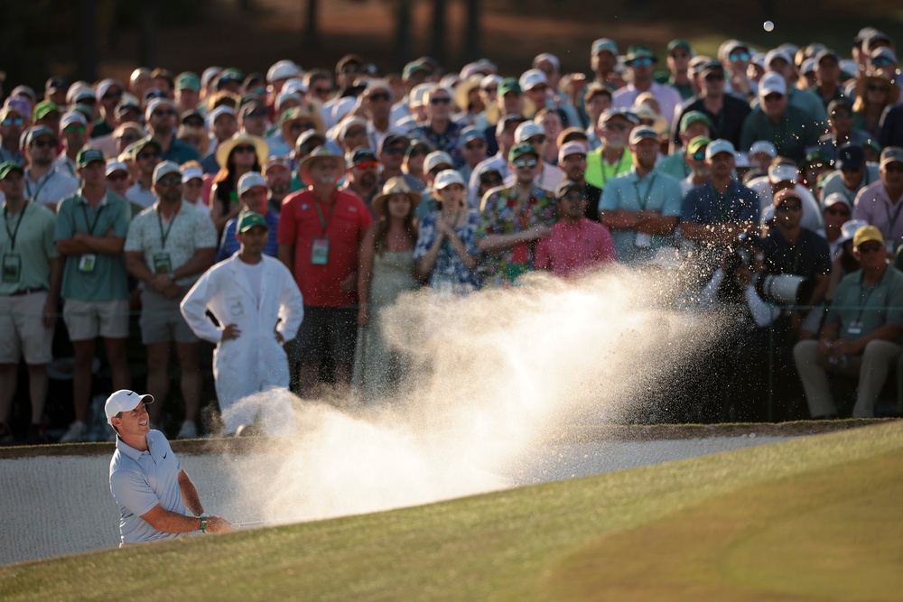 McIlroy was required to escape from the bunker on the 18th in order to avoid a double bogey (Getty)