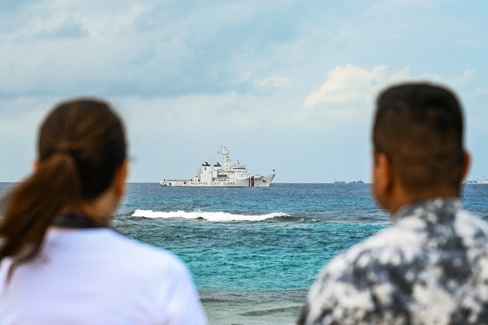 Philippine Senator Risa Hontiveros (L) and Commodore Jay Tarriela, spokesperson of Philippine Coast Guard for the South China Sea, look at a Philippine Coast Guard ship from Thitu Island in the South China Sea on February 21, 2026 (AFP/Getty)