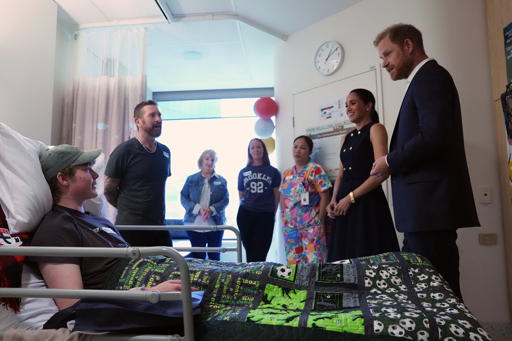 The Sussexes visit a patient at the Royal Children's Hospital Melbourne on Tuesday (AP)