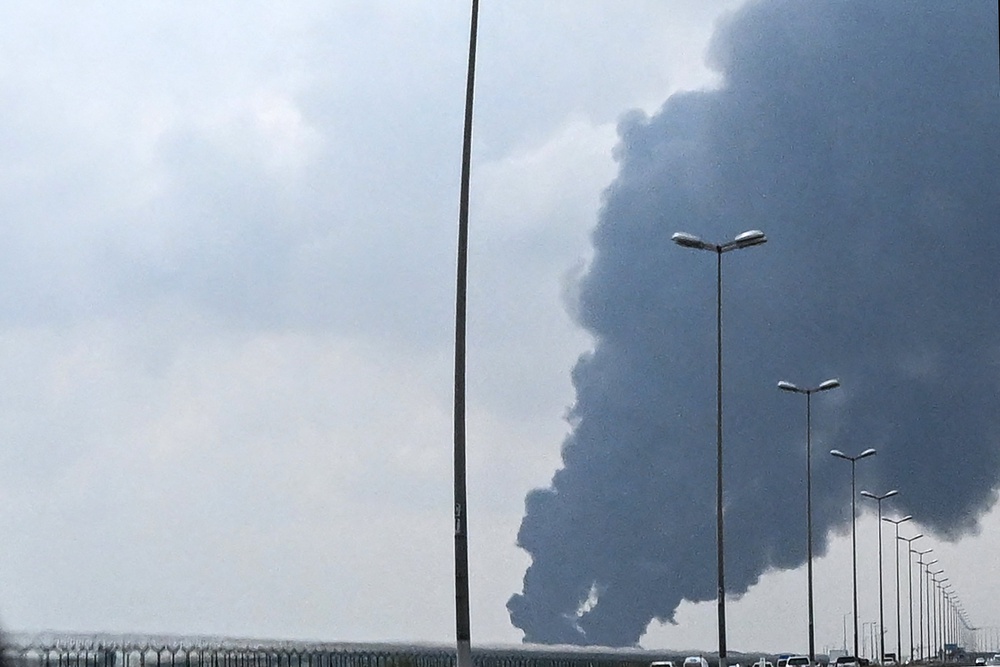 Smoke rises from the area of Kuwait international airport after a reported drone strike hit a fuel depot last month. Gulf countries called for Iran to immediately halt its strikes on their territory (AFP/Getty)