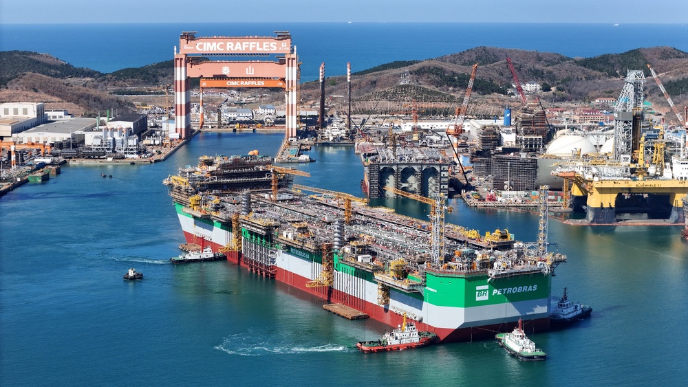 A photo taken on 7 April shows a floating production, storage and offloading vessel built for Brazilian oil producer Petrobras, being towed out of the dock by tugboats in Yantai, China (AFP/Getty)