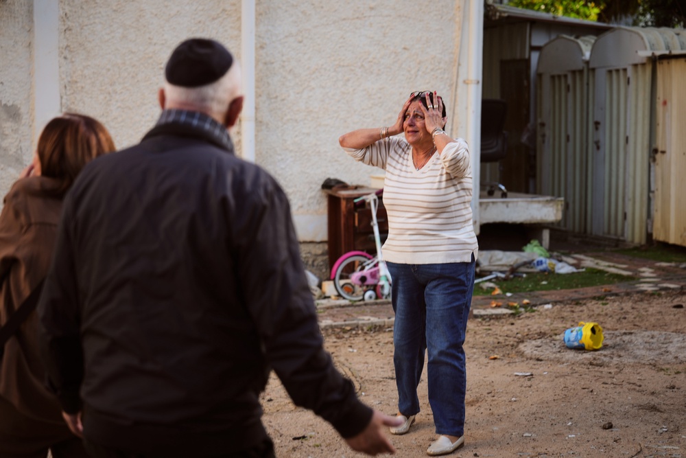 A woman reacts at the site of a damaged residential building after it was struck by a projectile fired from Lebanon (AP)