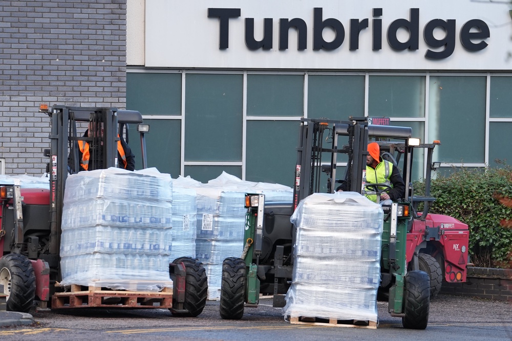 Bottled water is brought to Tunbridge Wells Sports Centre in December (Gareth Fuller/PA) (PA Wire)