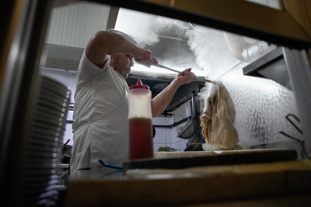 A man cooks traditional tripe soup, known as