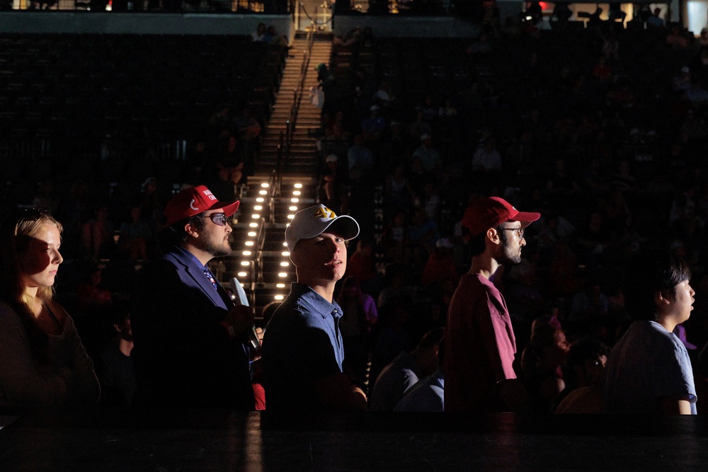 Young people wait in line to ask US Vice President JD Vance questions during a Turning Point USA event in the Akins Ford Arena (Reuters)