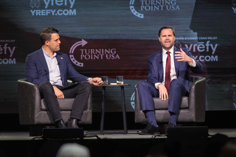 U.S. Vice President JD Vance (R) speaks with Turning Point USA spokesperson Andrew Kolvet during a Turning Point USA event (Getty)