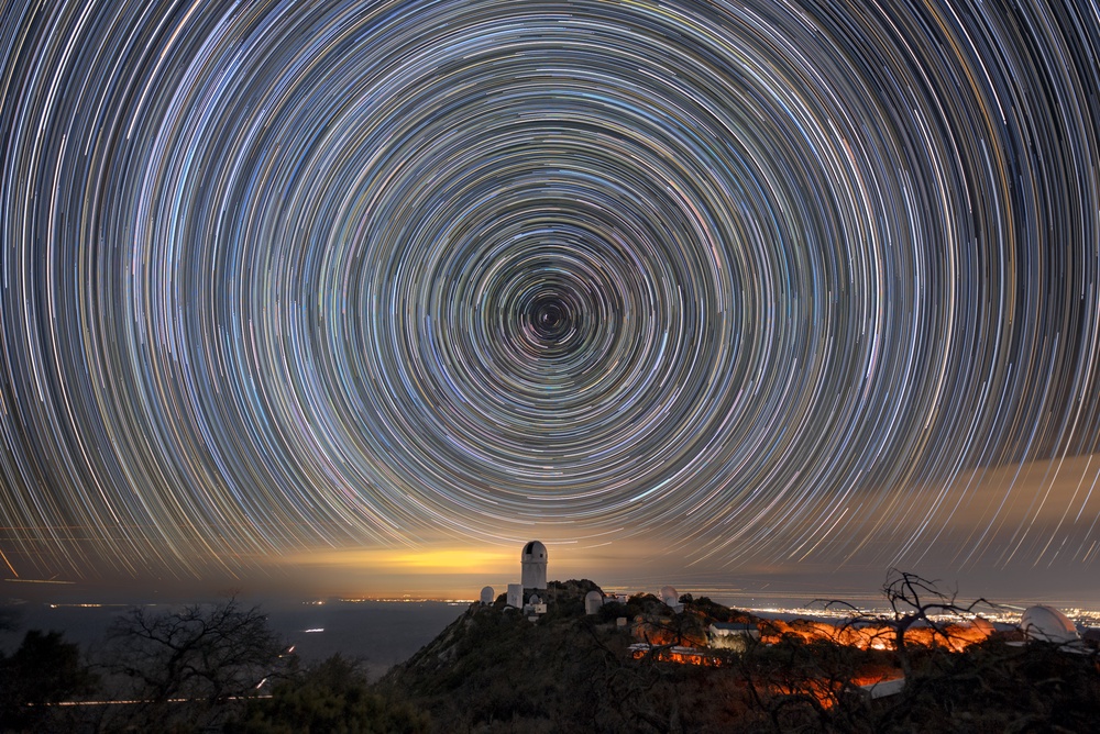 Star trails over the Mayall Telescope that houses DESI. (Luke Tyas/Berkeley Lab/KPNO/NOIRLab/NSF/AURA/PA)
