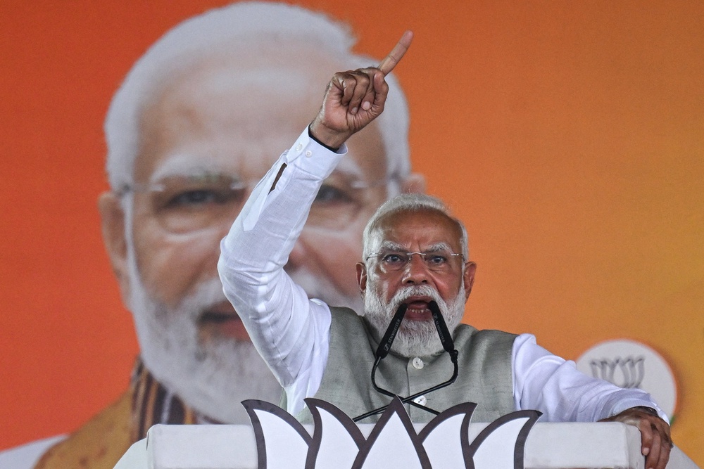 India's prime minister and Bharatiya Janata Party (BJP) leader Narendra Modi addresses his supporters during a mass rally in Kolkata on 14 March 2026 (AFP/Getty)