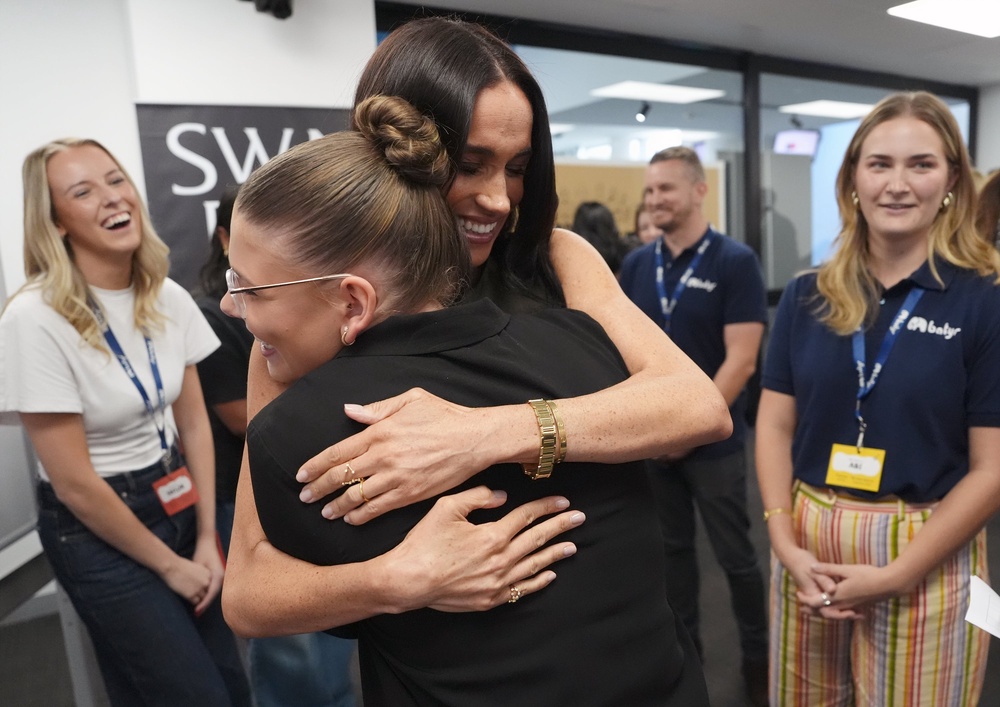 The Duchess of Sussex hugs young mental health advocates during a visit to Melbourne (PA)