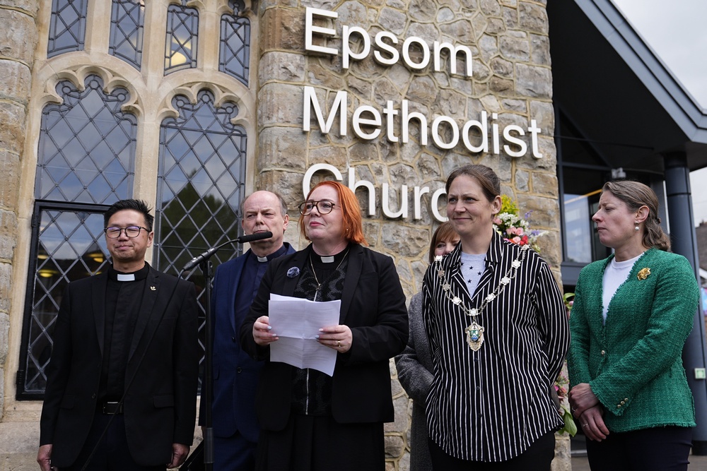 Reverend Catherine Hutton, centre, speaking to the media on Thursday (PA)