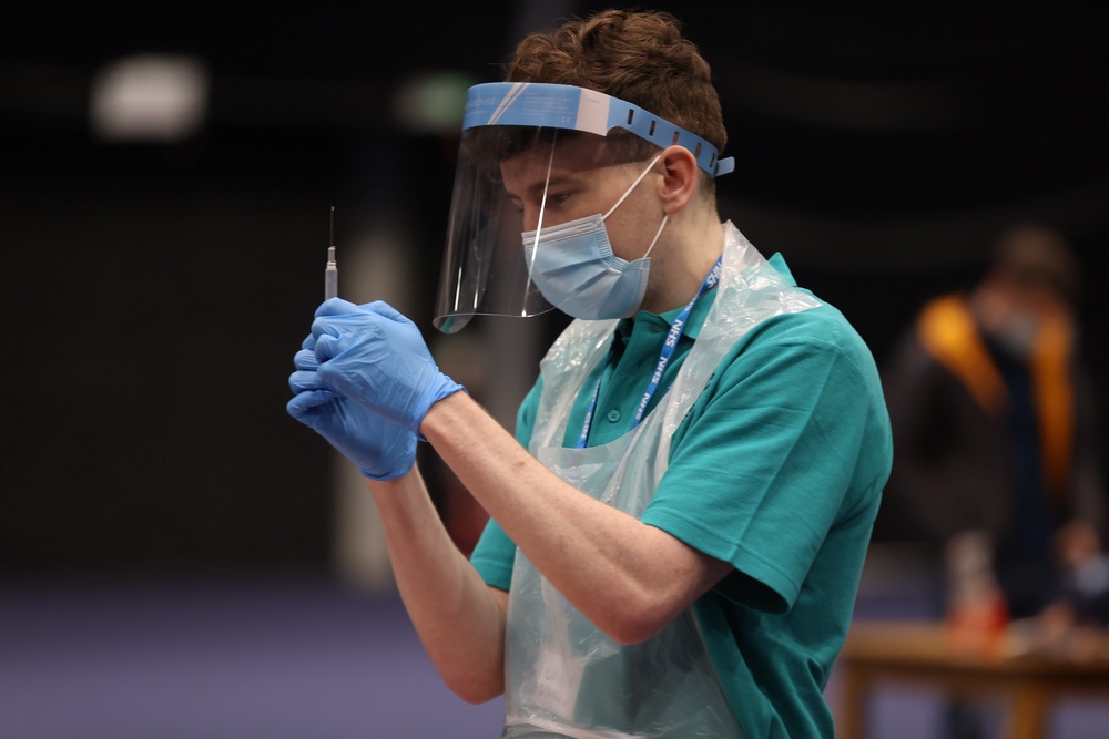 A vaccinator prepares vaccines at a Covid-19 booster vaccination centre in Belfast in 2021 (Liam McBurney/PA) (PA Archive)