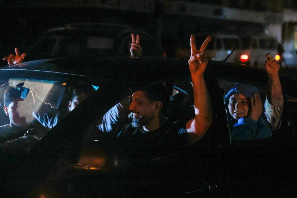 Supporters of Hezbollah celebrate the ceasefire with Israel as it takes effect, in the southern suburbs of Beirut, Lebanon, on Friday (AFP via Getty Images)