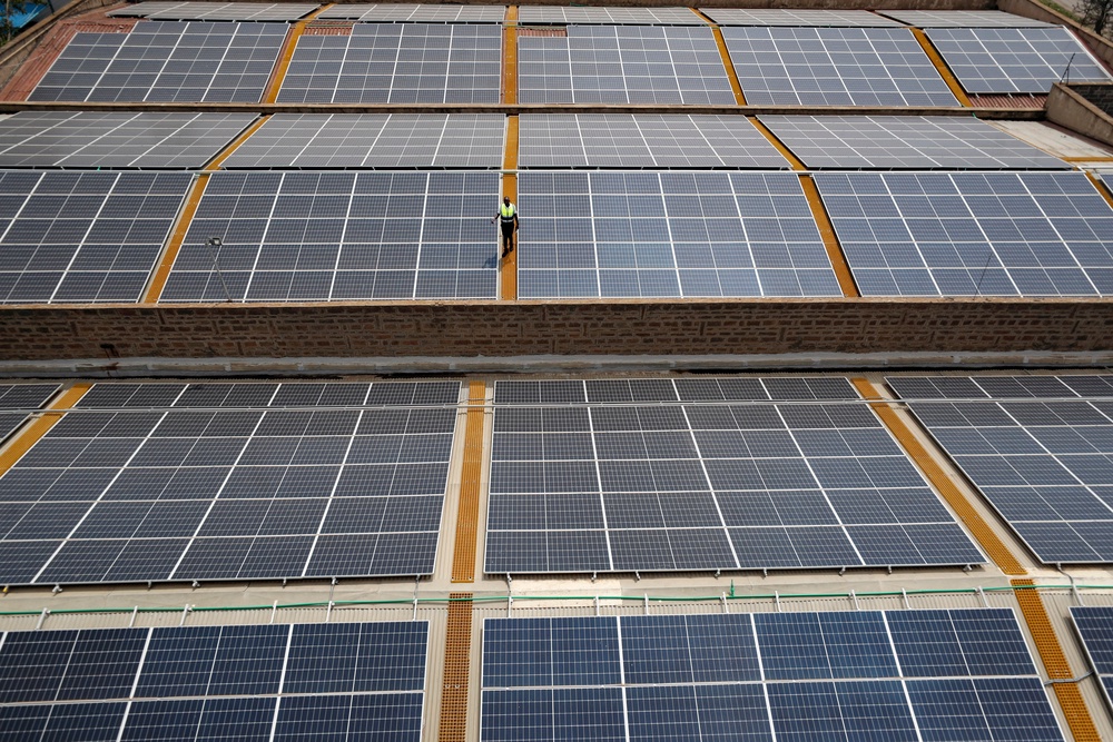 Mark Munyua, CP solar's technician, examines solar panels on the roof of a company in Nairobi, Kenya (Associated Press)