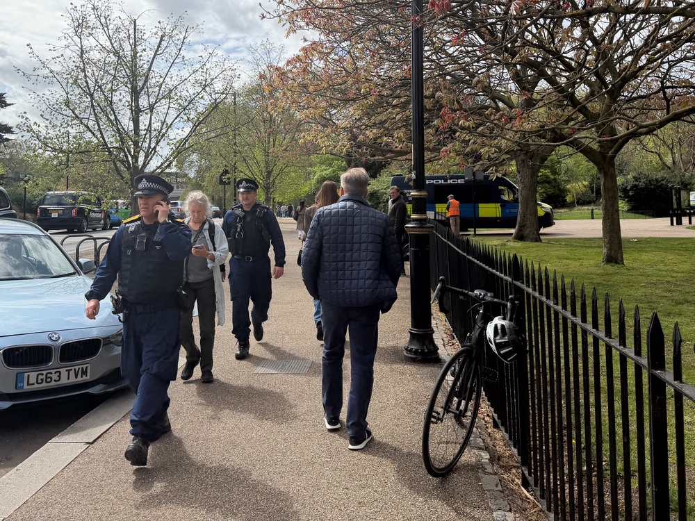 Police officers in Kensington Gardens, central London, investigating whether items found near the Israeli embassy are linked to a video which was posted online claiming it was going to be attacked (PA)