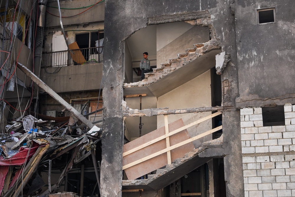 A boy looks on from a residential building that was hit by an Israeli air-strike, on April 17 (Getty)
