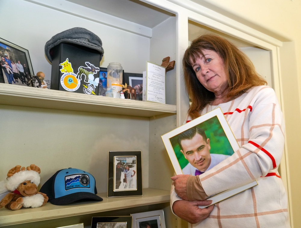 Kelley Nalewaja with a photo of her son Michael (AP)