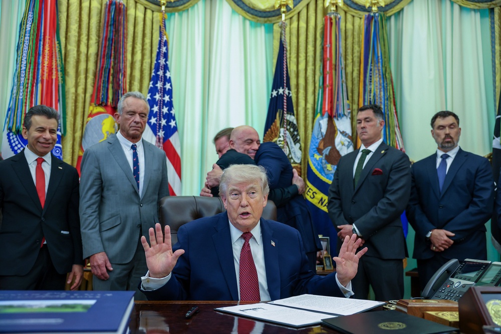 President Donald Trump speaks in the Oval Office as he signs an Executive Order on 18 April (Getty)
