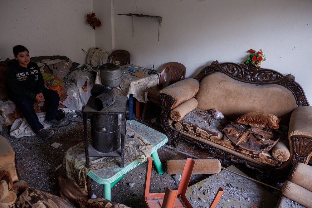 Sajed Dahnoun, 12, who said he survived an Israeli strike that forced him to flee with his parents to Beirut, sits in his neighbours' sitting room in Nabatieh on 18 April, since the ceasefire (Reuters)