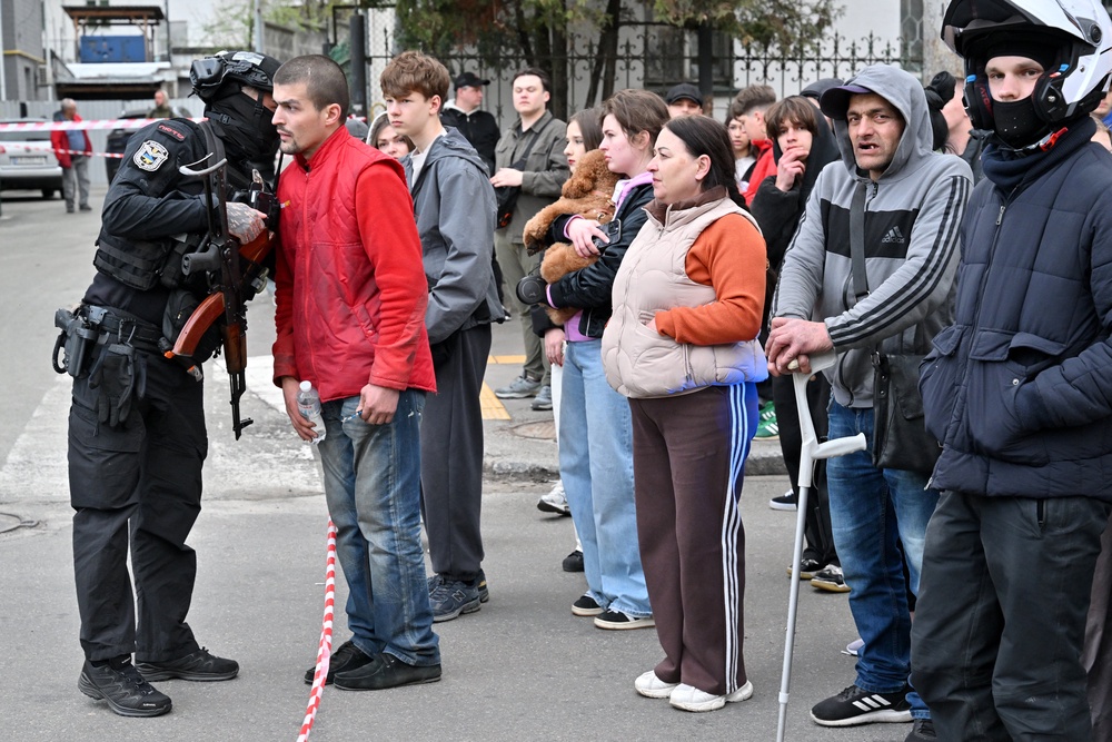 People stand outside a supermarket following a shooting in Kyiv (AFP/Getty)